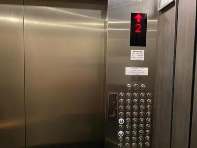 an elevator with a sign on the side of it at Cosmopolitan Comfort Makati 1 BR Wonder 300MB 2428 Internet in Manila