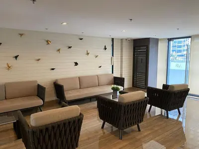 a living room with a couch and chairs and birds on the wall at 3 Bedroom Air condo Pool Perfect Holiday Gym Swim 300 Mbps in Manila
