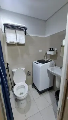 a bathroom with a toilet and a sink at Vanilla Suites Mall of Asia Complex in Manila