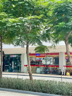 a fast food restaurant with trees in front of it at Vanilla Suites Mall of Asia Complex in Manila