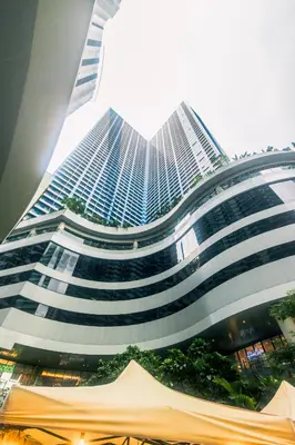 a large building with a lot of windows at Cozy Peacock hideaway Stylish Makati Condo 300 Mbps Gym Swim Park in Manila