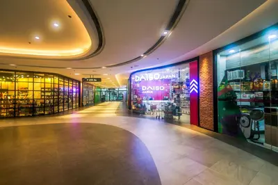 a shopping mall with a dacus sign on the wall at Cozy Peacock hideaway Stylish Makati Condo 300 Mbps Gym Swim Park in Manila