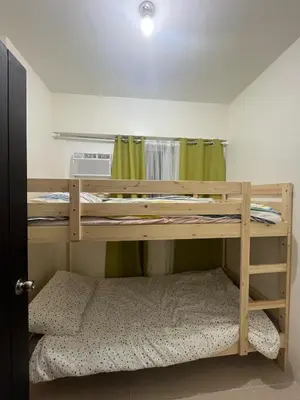 a bedroom with two bunk beds in a room at 3BR at The Rochester in Manila