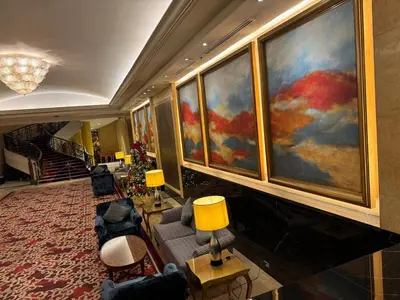 a lobby with a large painting on the wall at Galloping Suite Executive Makati Suite Gym Swim Park 300 Mbps in Manila