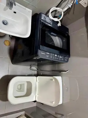 a microwave sitting on a counter next to a sink at Galloping Suite Executive Makati Suite Gym Swim Park 300 Mbps in Manila