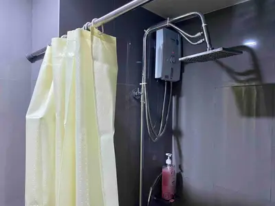 a shower in a bathroom with a shower curtain at Jazz Air Rooftop Penthouse Bar Gym Swim Park 300 Mbps Air 4034 in Manila