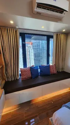 a window seat in a bedroom with blue and red pillows at Air residence Fantasy Sophisticated Heaven on earth Gym Swim Park 300 MB in Manila