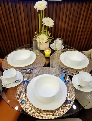 a table with white plates and silverware on it at Makati Broadway Bliss Golden spot Gym Swim Park 300 Mbps 1940 in Manila