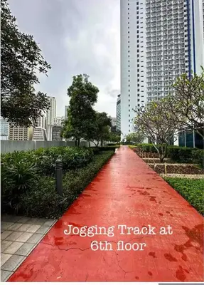 a red path in the middle of a city at High Rise Haven in Makati with Balcony and View in Manila