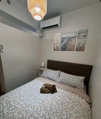 a bedroom with a bed with a stuffed animal on it at Hearth of Ember 2 at Shore 3 Residences in Manila