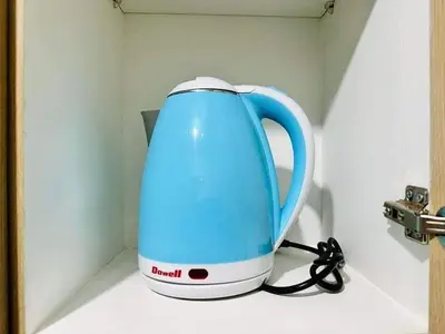 a blue tea kettle sitting on top of a counter at Niereys Suite 1071 in Manila