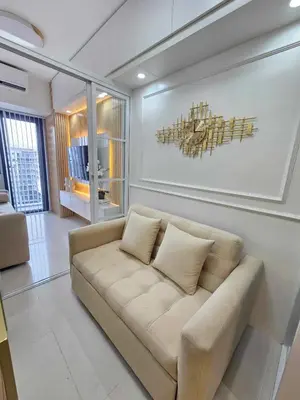 a living room with a couch and a painting on the wall at Shore 3 Tower 4 Amenity View Pasay in Manila