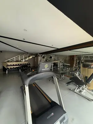 a gym with a treadmill and a mirror at Luxurious Studio Unit in Salcedo in Manila