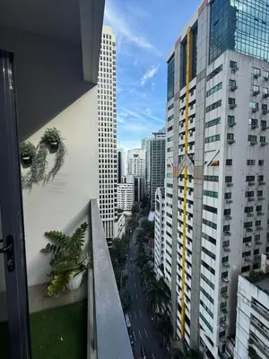 a balcony with plants on the side of a building at Luxurious Studio Unit in Salcedo in Manila