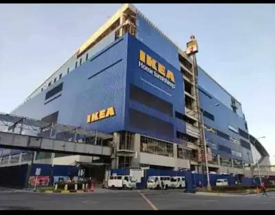 a large blue building with vans parked in front of it at Shore Residence 1 Bedroom Staycation in Manila
