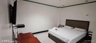 a bedroom with a bed and a flat screen tv at Asia Novo Boutique Hotel - Cabuyao Laguna in Cabuyao
