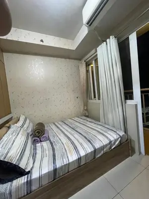 a small bed in a room with a window at Shell residence moa in Manila