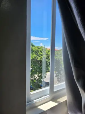 a window with a view of a tree at TheMudroomStyle ideal WFH near St Benedict Parish in Silang