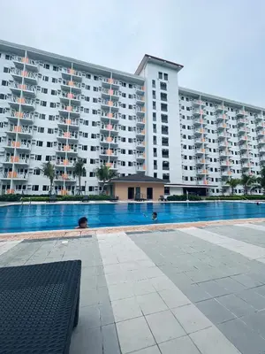a large apartment building with a large swimming pool at Field Residences Condo Hotel in Manila