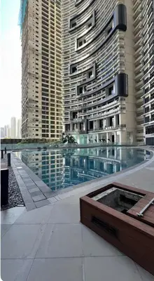 a pool in front of some tall buildings at ElixirStaycation at Knightsbridge Residences in Manila