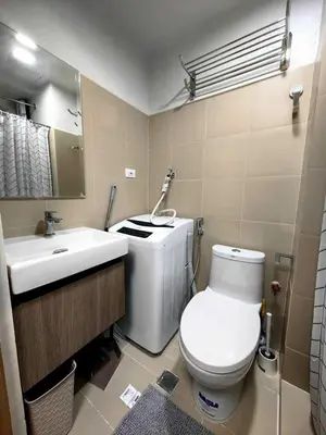 a bathroom with a toilet and a sink at Luxurious Condo Near SM MOA in Manila