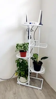 a white shelf with plants and a laptop on it at Joms Minimalist Crib Nuvali in Calamba