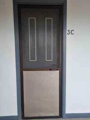 a glass door with a metal screen on it at Flat 35, Unit 3C in Manila