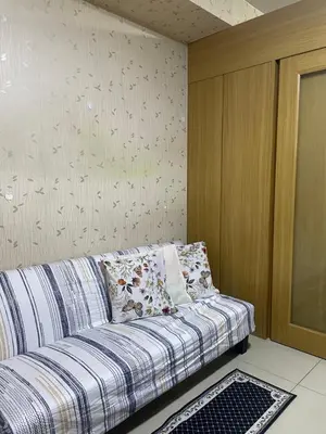 a couch with pillows on it in a room at 10hrs stay in Manila