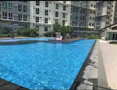 a large blue swimming pool in front of a building at Phebestaycation in Manila