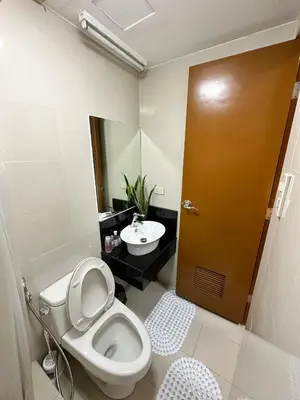 a bathroom with a toilet and a sink at Casa Broganza in Manila