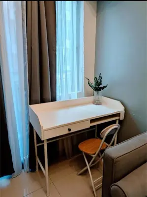 a desk in a room with a window and a chair at Mall of Asia Condo Pasay in Manila