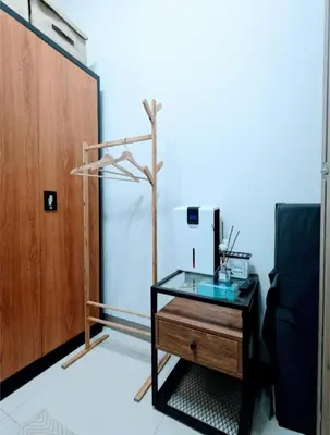 a room with a glass table and a wooden door at Mall of Asia Condo Pasay in Manila