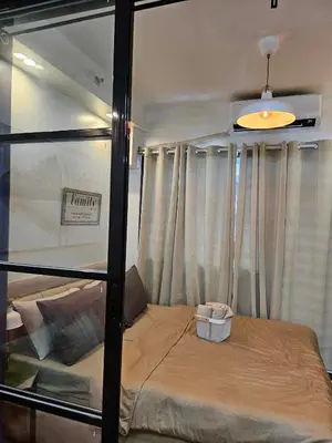 a bed in a room with curtains and a window at Adventura Staycation in Manila