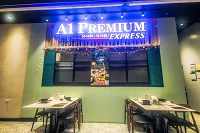 a restaurant with two tables and a sign on the wall at Air residence Snuggle in Style 1 BR condo Makati swim gym park surf 300 Mb in Manila