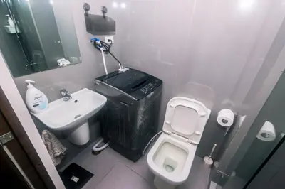 a small bathroom with a toilet and a sink at Air residence Snuggle in Style 1 BR condo Makati swim gym park surf 300 Mb in Manila
