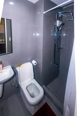 a bathroom with a toilet and a shower and a sink at Urban Oasis Sleep in Style Makati Comfy Gym Swim Park 914 in Manila