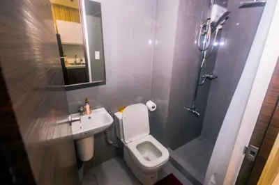 a bathroom with a toilet and a sink and a shower at Urban Oasis Sleep in Style Makati Comfy Gym Swim Park 914 in Manila