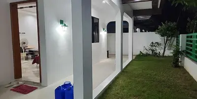 a room with a hallway with a mirror and grass at Short Stay BF Resort in Manila