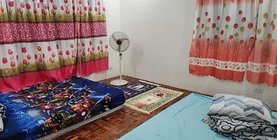 a room with two beds and a fan in it at Short Stay BF Resort in Manila