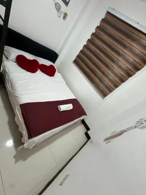 a bedroom with a bed with red pillows on it at 143 Private Resort in Trece Martires