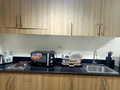 a kitchen counter with a toaster and a sink at Staycation in Shore Residence's in Manila