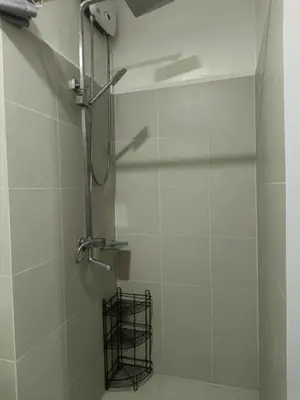 a shower with a glass door in a bathroom at SMDC Red residences Condominium Makati City in Manila