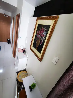 a painting of a vase of flowers on a wall at Aldo mall of Asia shore 3 residence in Manila
