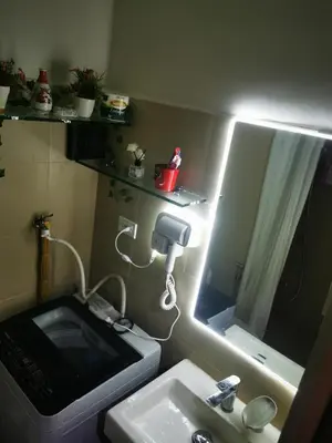 a small bathroom with a sink and a mirror at Aldo mall of Asia shore 3 residence in Manila