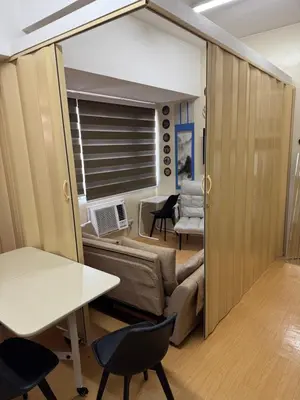 a living room with a couch and a table at Greenhills commercial center 1-2BR condominium in Manila