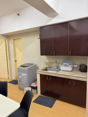 a kitchen with a sink and a counter top at Greenhills commercial center 1-2BR condominium in Manila