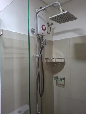 a shower with a shower head in a bathroom at Simplicity in Manila