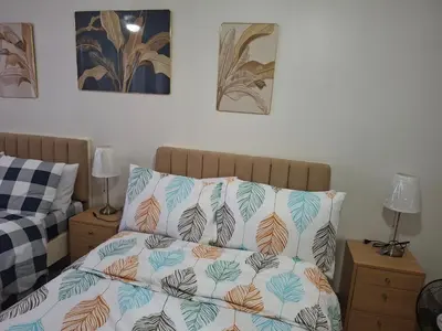 a bed with two pillows on top of it at Simplicity in Manila