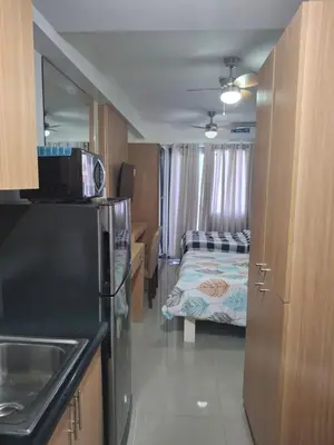 a small room with a kitchen and a bed at Simplicity in Manila