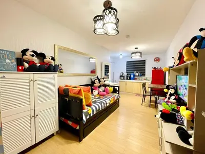 a childs room with a bed and stuffed animals at Staycation with Mickey & Minnie One Oasis Pasig in Manila